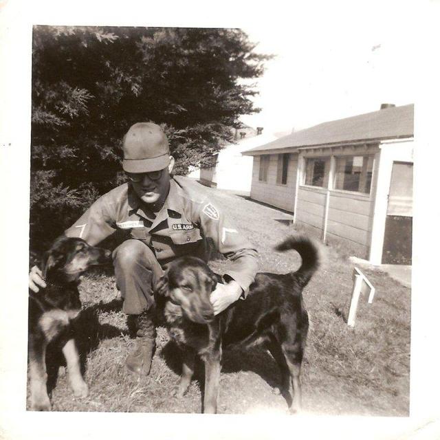 Behind B-2-51 mess hall. That's me, Paul Petosky, with sentry dogs (1963).